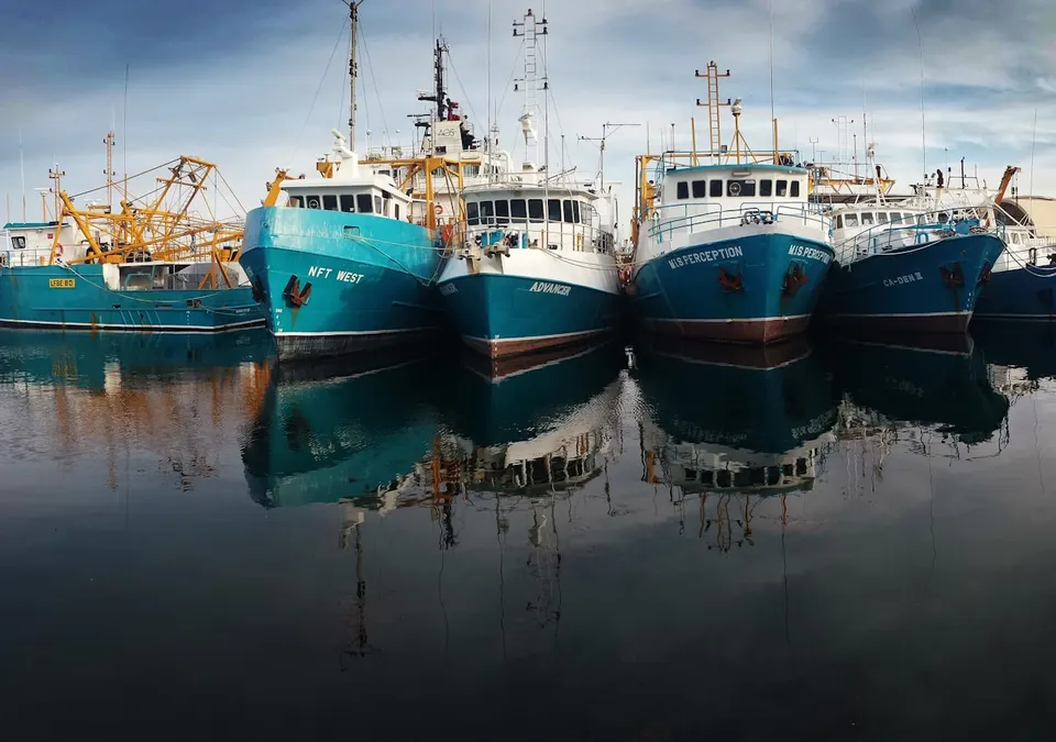 Fishing vessels moored alongside a harbour quay